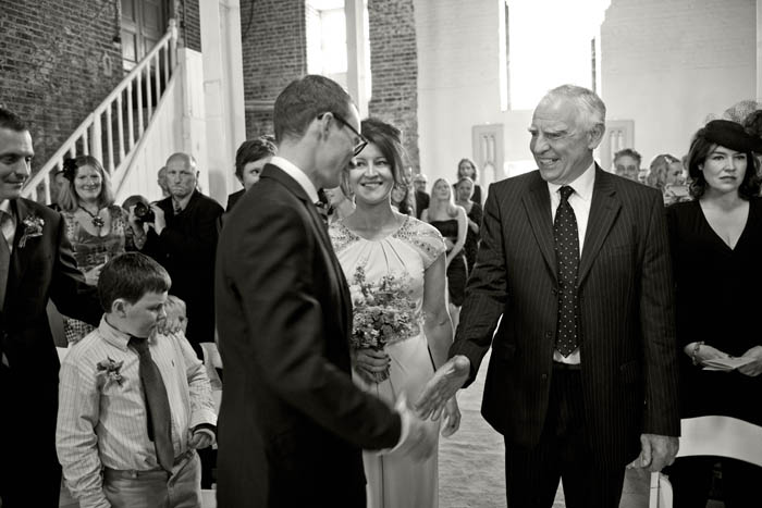 father of the bride shaking hands with groom